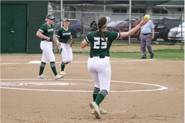 Colleen Palczynski throwing the ball around the horn after completing the out at first
Photo: Illinois Wesleyan University 
