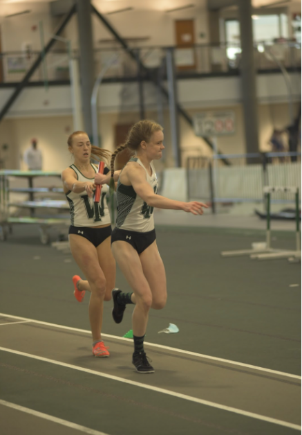 Senior Cora Wilkinson hands off the baton to junior Rebekah Harden in the 4x400 meter relay. 
Photo: Illinois Wesleyan University 
