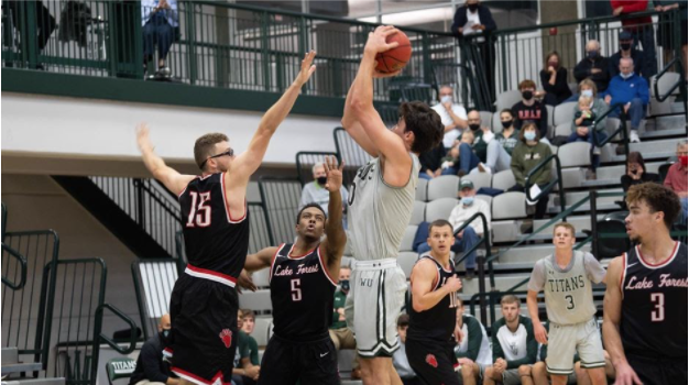 Senior captain Matthew Leritz shoots and scores in the first game of the basketball season. Photo: IWU Sports